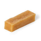 Three-quarter view of Himalayan yak cheese chew dog treat showcasing hard rectangular cheese texture on white background