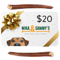 Front view of Mika & Sammy’s gift card centered between two smoked bully sticks on a white background