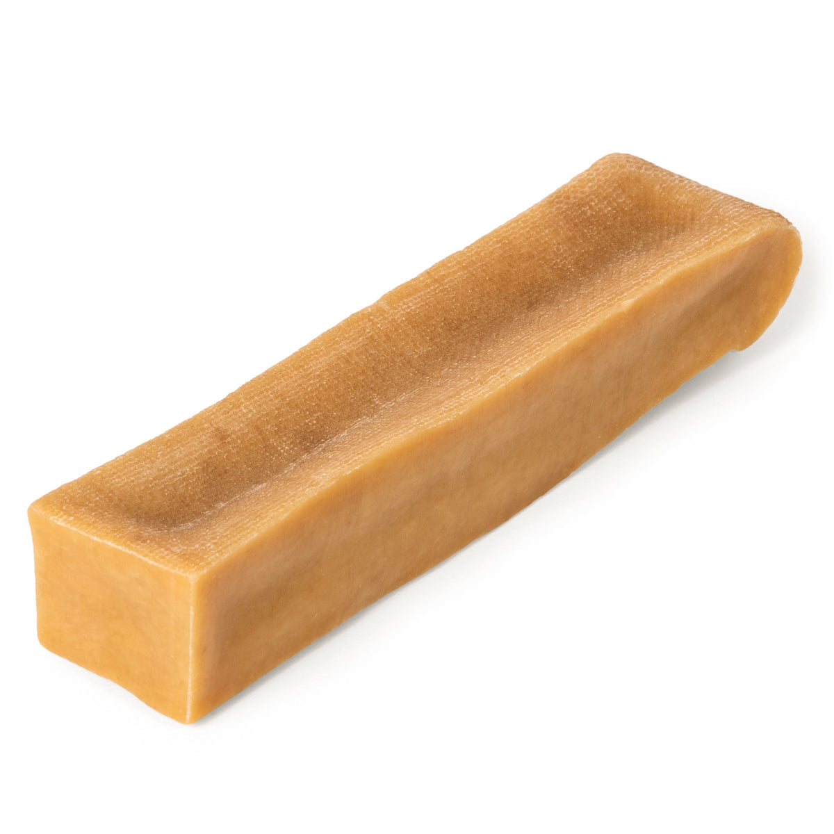 Close-up of extra-large Himalayan yak cheese chew showcasing hard, dense texture and pale tan color with dark background