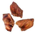 Overhead view of Pig Ears showcasing three brown dog chews on a transparent background