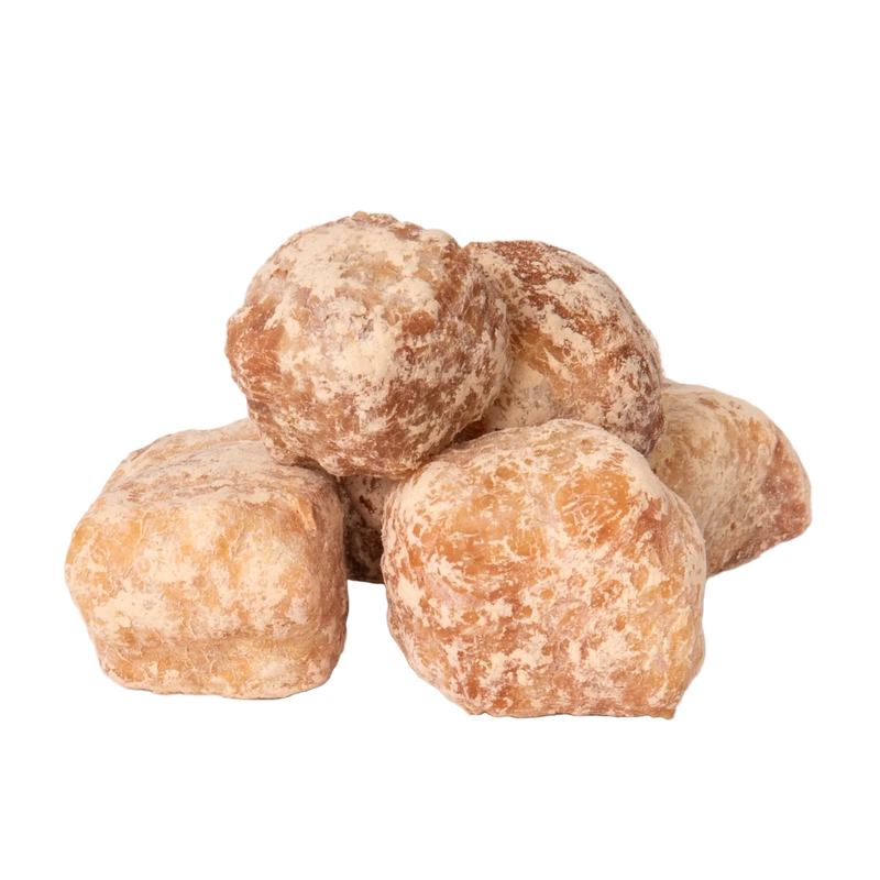 Close-up of Peanut Butter Yak Cheese Puffs showcasing their round, powder-coated texture on a transparent background