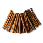 Close-up of hickory smoked bully sticks showcasing smoked brown color and firm twisted texture on white background