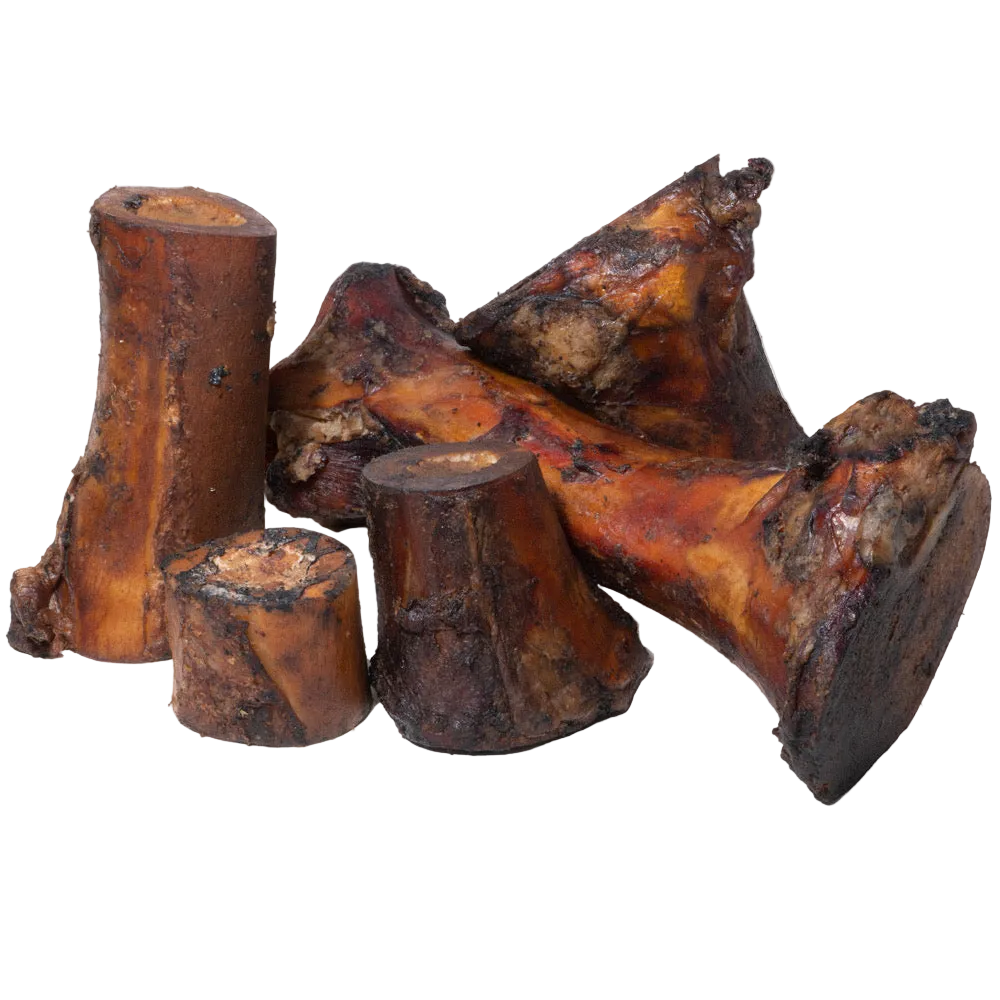 Angled view of smoked beef marrow bones showcasing browned smoked exteriors and cut marrow ends on a transparent background