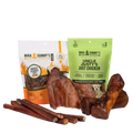 Front view of a pet treat bundle showcasing smoked chicken feet, chicken jerky treats, bully sticks, and chews on a transparent background