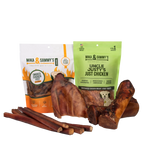 Front view of a pet treat bundle showcasing smoked chicken feet, chicken jerky treats, bully sticks, and chews on a transparent background