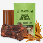 Front of Cici’s medium dog bundle: green Uncle Justy’s chicken jerky bag, smoked marrow bones, bully sticks, chicken feet