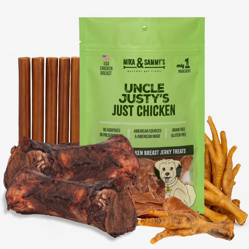 Front of Cici’s medium dog bundle: green Uncle Justy’s chicken jerky bag, smoked marrow bones, bully sticks, chicken feet