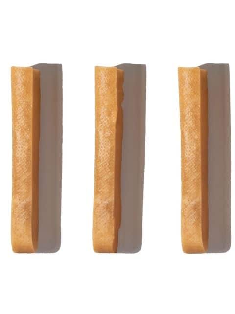 Front view of a medium Himalayan yak cheese chew dog treat showcasing its solid cylindrical shape and textured brown surface on white background