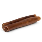 Close-up of two Monster Beef Cheek Sticks showing rolled hollow center and firm brown chew texture on a white background