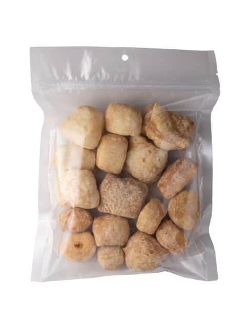Front view of 5 oz bag of Peanut Butter Yak Cheese Puffs showing chunky cheese puffs inside a clear resealable bag on white background