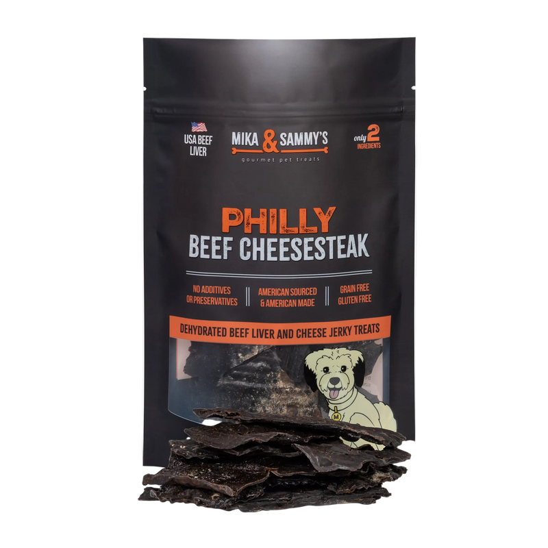 Front view of Philly Beef Cheesesteak dog treats showcasing dehydrated beef liver and cheese jerky treats with loose treats in front