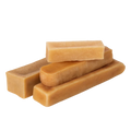 Three-quarter view of Himalayan yak cheese chew dog treats showcasing assorted rectangular shapes on black background