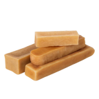 Three-quarter view of Himalayan yak cheese chew dog treats showcasing assorted rectangular shapes on black background