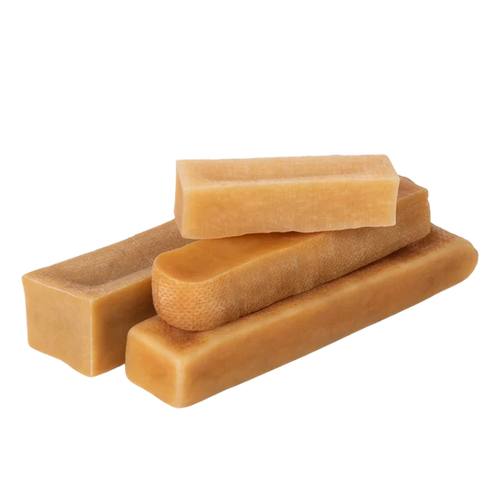Three-quarter view of Himalayan yak cheese chew dog treats showcasing assorted rectangular shapes on black background