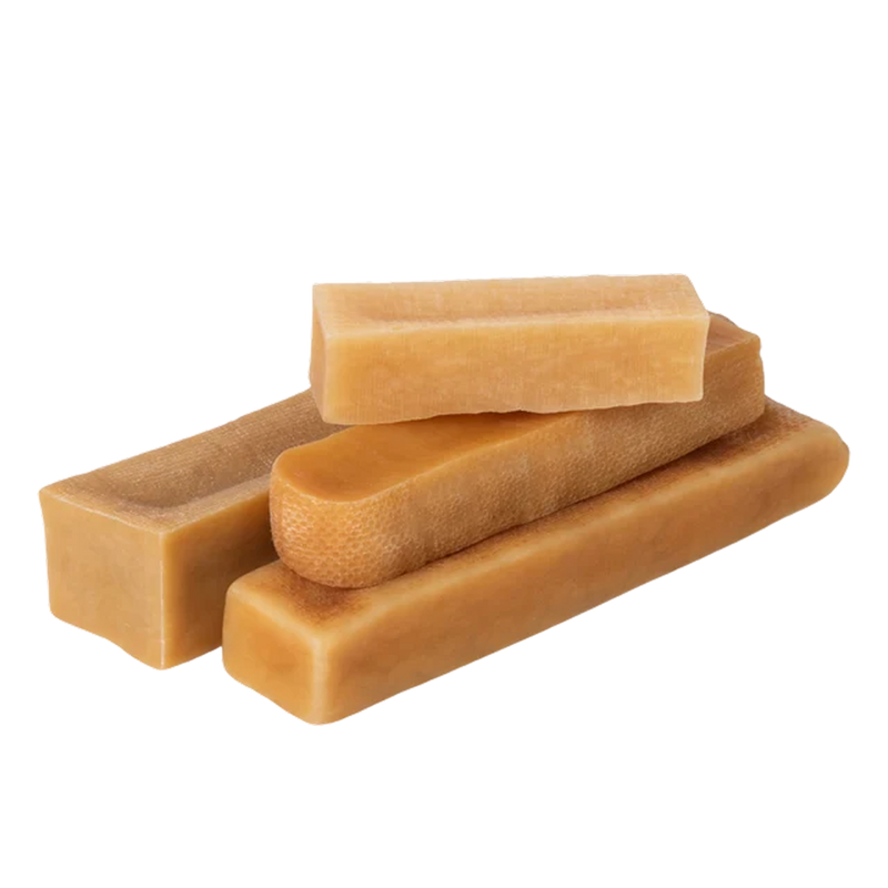 Three-quarter view of Himalayan yak cheese chew dog treats showcasing assorted rectangular shapes on black background